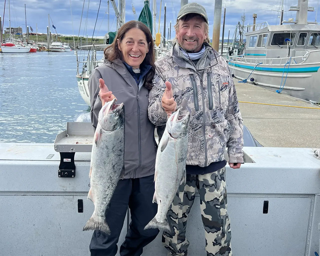 Homer Halibut Hunter customer Frank Anderson, from Bozeman, MT holds up the silver salmon the caught on their combo halibut and salmon fishing charter